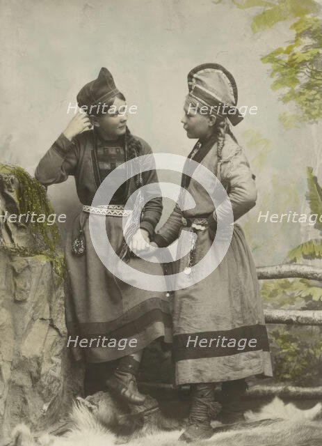 Studio portrait:Two young Sami women dressed in black, 1890-1899. Creator: Helene Edlund.