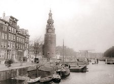 Barges on the canal in front of the Montelbaanstoren, Amsterdam, 1898.Artist: James Batkin