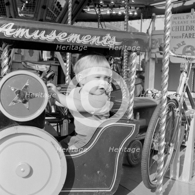 Child on a fairground ride, Hampstead, London, 1962-1964. Artist: John Gay