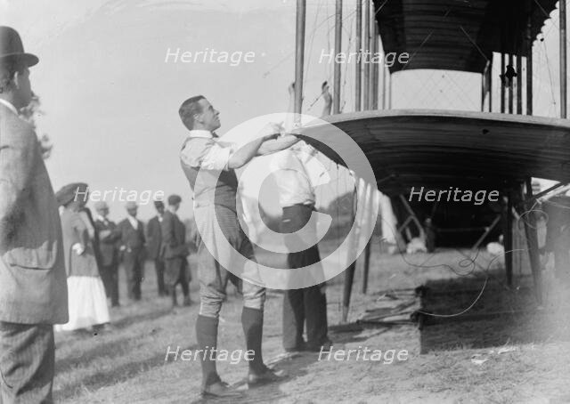 Claude Grahame-White - Fixing Wing of His Forman Plane, 1910. Creator: Harris & Ewing.