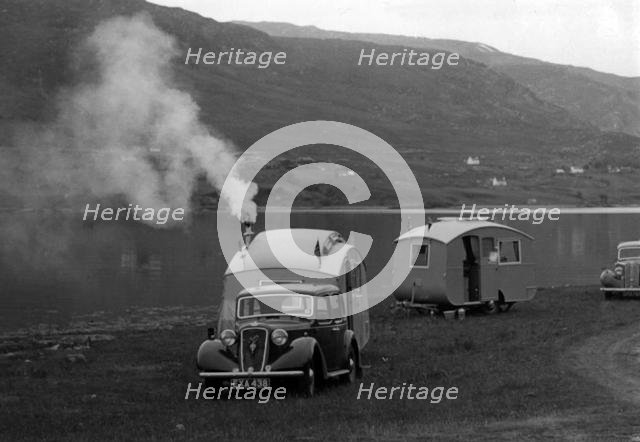 1937 Austin 12hp saloon with caravan. Creator: Unknown.