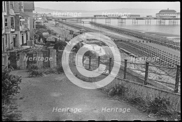 View looking south along the beach at Shanklin, showing Admiralty scaffolding, Isle Of Wight, 1945. Creator: George R Long.