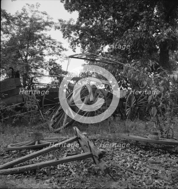 Abandoned coaches and wagons...old blacksmith shop, Wray Plantation, Greene County, Georgia, 1937. Creator: Dorothea Lange.