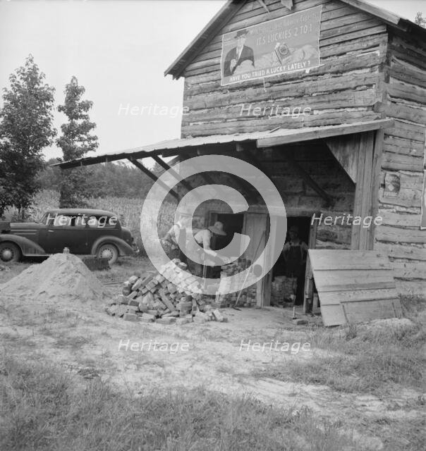 Putting in new flues in tobacco barn, Orange County, North Carolina, 1939. Creator: Dorothea Lange.