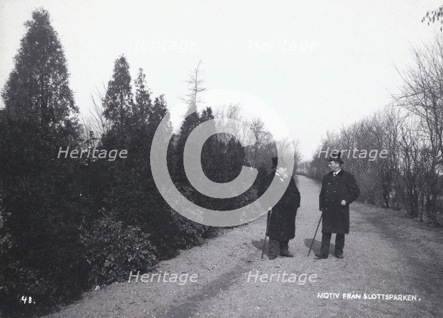 Two men walking in the Castle Park, Landskrona, Sweden, 1900.  Artist: Borg Mesch
