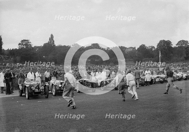 Drivers running to their cars at the start of a race at Crystal Palace, London, 1939. Artist: Bill Brunell.