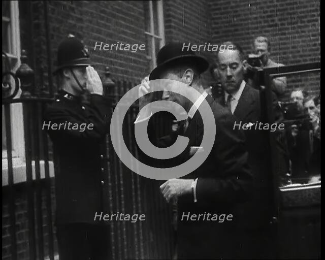A Male British Police Officer Saluting King George VI, the British Monarch who is Exiting..., 1939. Creator: British Pathe Ltd.