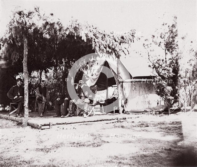 [Four men in camp under a lean-to of pine boughs], 1861-65. Creator: Unknown.