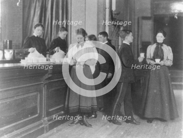 Students getting beverages from a counter, Western High School, Washington, D.C., (1899?). Creator: Frances Benjamin Johnston.