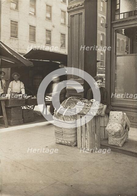 Lena Lochiavo - 11 years old, basket (and pretzel) seller, at Sixth Street Market in front of saloon Creator: Lewis Wickes Hine.