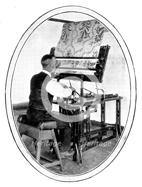 A preliminary to the weaving of figured goods: transferring a design to jacquard cards, 1909. Creator: Unknown.