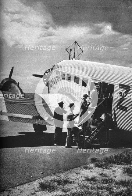 Passengers boarding one of the Junkers airliners of South African Airways, c1936 (c1937). Artist: Unknown.