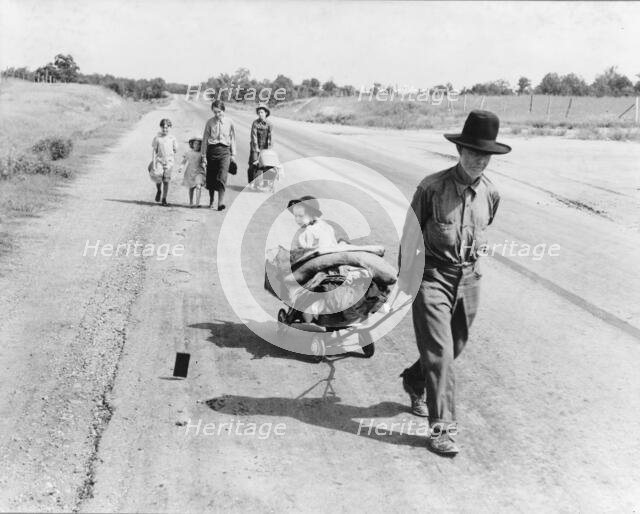 Family walking on highway, five children, Pittsburg County, Oklahoma, 1938. Creator: Dorothea Lange.