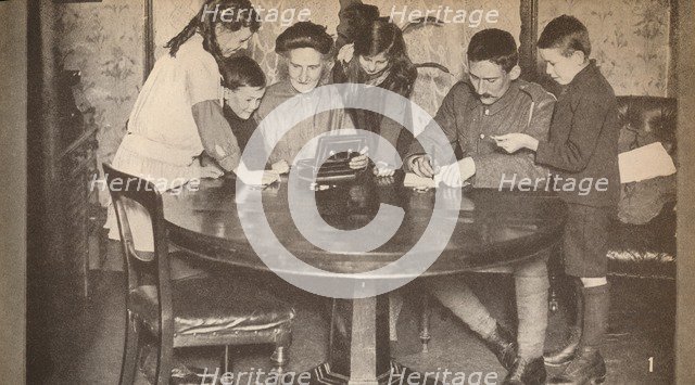 'Children emptying their money-boxes to invest in war loan', c1917, (1935). Artist: Unknown.