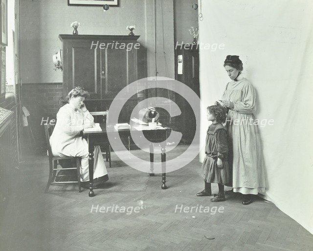 School nurse examining girls' hair for head lice, Chaucer School, London, 1911. Artist: Unknown.