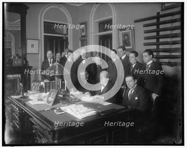 William Jennings Bryan with group at desk, between 1910 and 1920. Creator: Harris & Ewing.