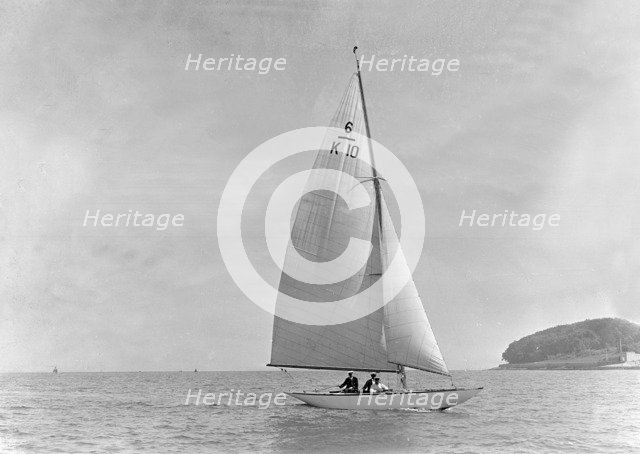 The 6 Metre yacht 'Polly' (K10) sailing upwind, 1921. Creator: Kirk & Sons of Cowes.
