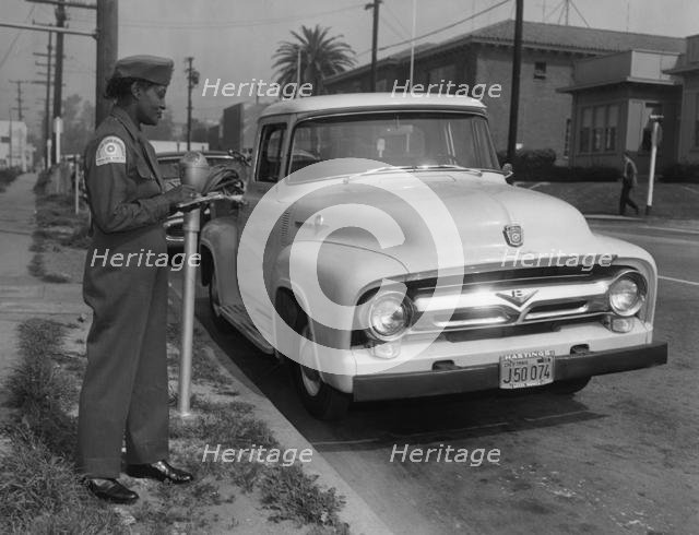 Parking meter with Los Angeles parking control officer 1958. Creator: Unknown.