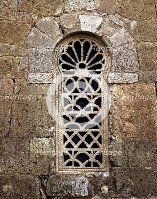 Window in the apse with a Visigothic lattice, in the church of San Juan de Baños.