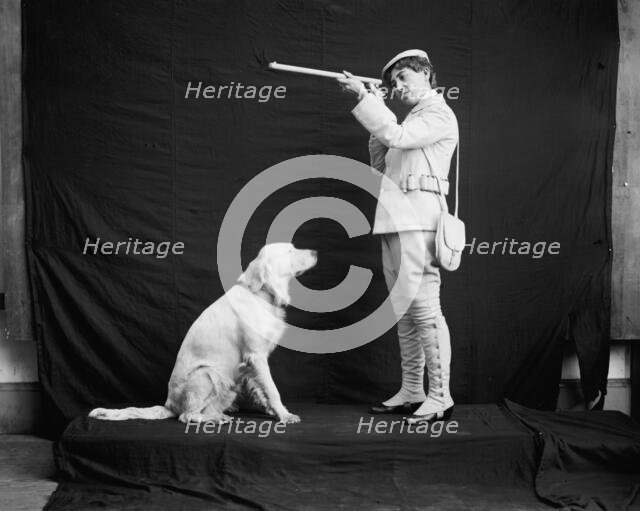 Billy and his mistress in hunting poses, between 1895 and 1910. Creator: Unknown.