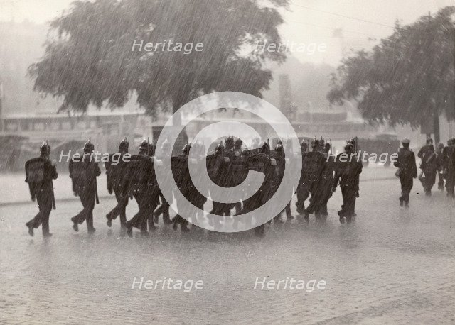 Soldiers returning to their base in a cloudburst, Stockholm, Sweden, 1934. Artist: Karl Sandels