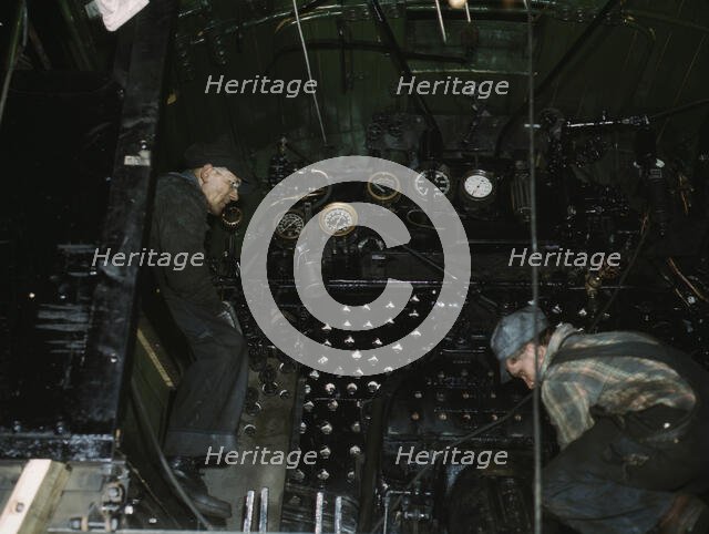 Working on the cab of a locomotive brought in for repair at the C & NW RR, Chicago, Ill., 1942. Creator: Jack Delano.