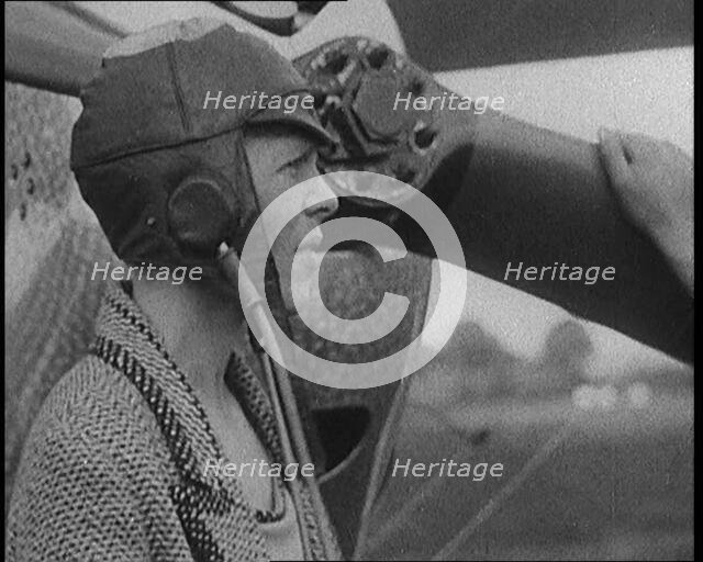 American Aviator Amelia Mary Earhart Wearing a Helmet in Front of an Airplane, 1920. Creator: British Pathe Ltd.