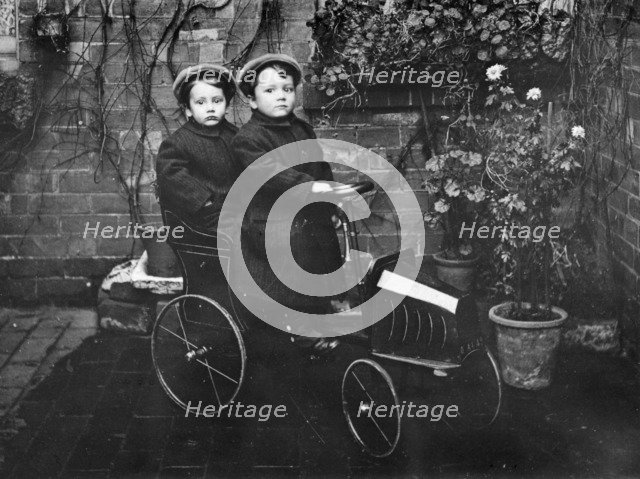 Two boys in a pedal car, (early 20th century?). Artist: Unknown