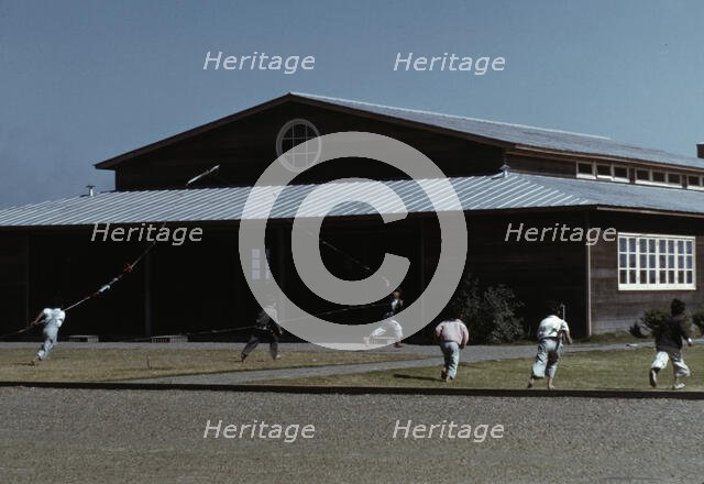 Boys flying a kite in front of community center, FSA ... camp, Robstown, Tex., 1942. Creator: Arthur Rothstein.