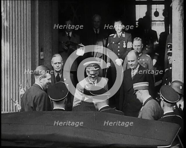 A Close up of Adolf Hitler, the German Leader, on the Front Steps of a Building Leaning..., 1938. Creator: British Pathe Ltd.