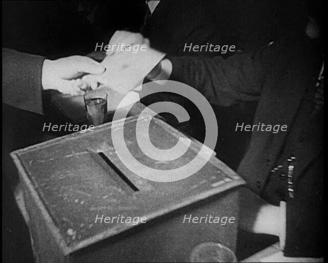 Men Sitting Around a Ballot Box, 1933. Creator: British Pathe Ltd.