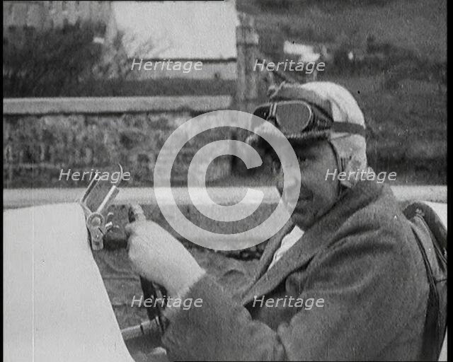 Close up Shot of John Godfrey Parry-Thomas Behind the Wheel of a Car Wearing a Racing Helmet, 1927. Creator: British Pathe Ltd.