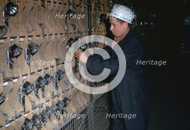 Coal miner collecting his lamp.