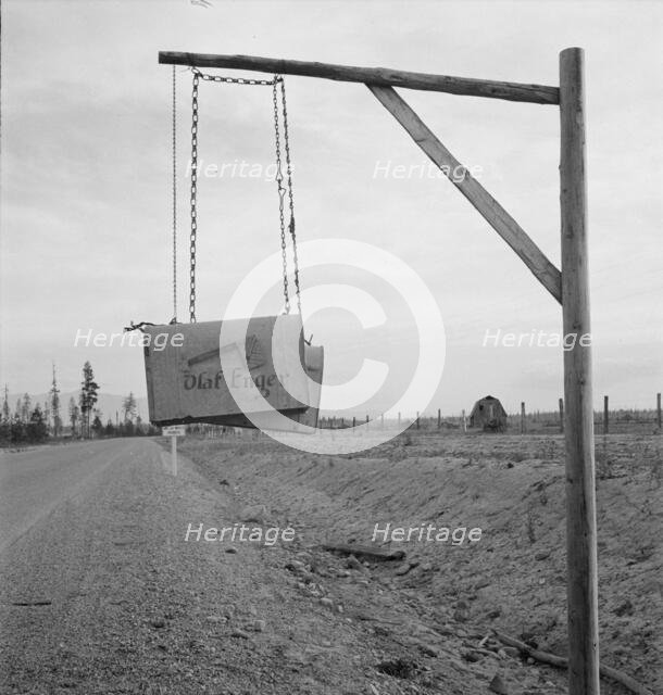 Swinging mail boxes in country where snow is deep in winter, Boundary County, Idaho, 1939. Creator: Dorothea Lange.