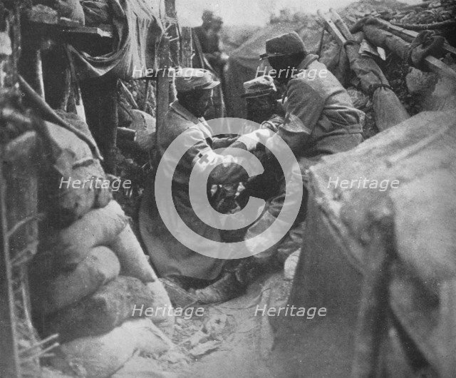'First aid to a wounded man in one of the French trenches', 1915. Artist: Unknown.