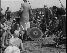 Civilians Wearing Swimsuits Leasuring on a Beach, 1920. Creator: British Pathe Ltd.