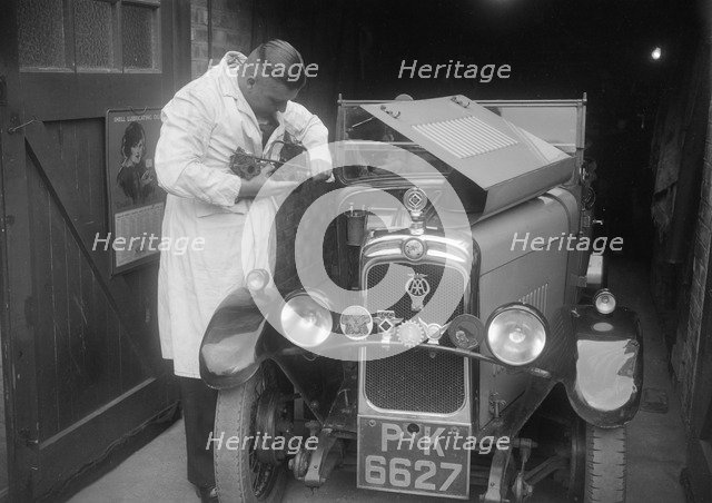 FA Thatcher working on his 1929 Triumph Super Seven. Artist: Bill Brunell.