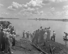 Baptism by immersion in the MIssissippi River, May 29, 1938: ankle-deep in water. Creator: Frances Benjamin Johnston.