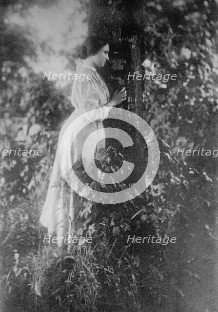 Helen Keller, standing next to tree, 1912. Creator: Bain News Service.