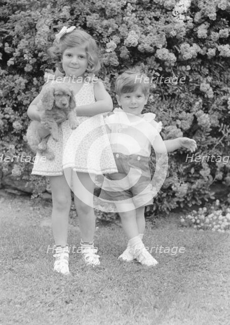 Javits, Benjamin, children of, with dog, standing outdoors, 1933 July. Creator: Arnold Genthe.