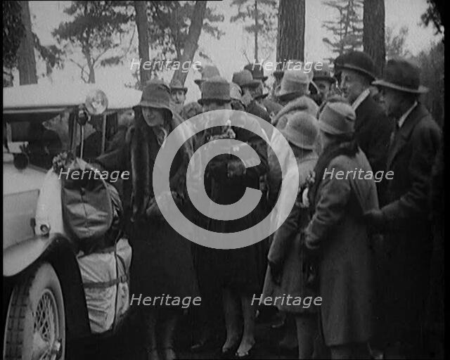 Two Female Civilians Wearing Heavy Coats and Hats Embarquing a Luggage Loaded Car Watched by...,1920 Creator: British Pathe Ltd.