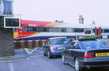 Traffic queue at level crossing in Brockenhurst, Hampshire. Artist: Unknown.