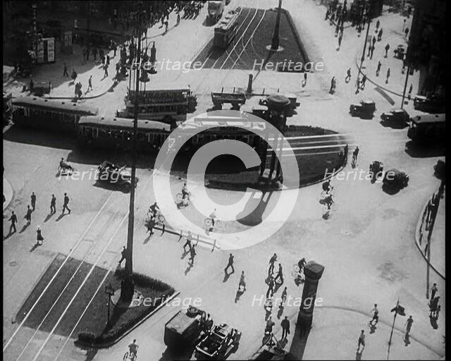 Aerial Shot of a Tram Line with People Walking Around, 1933. Creator: British Pathe Ltd.