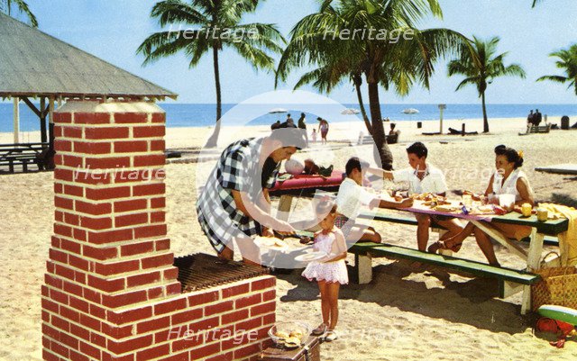 A family enjoying a picnic and barbecue on a sandy beach in Florida, USA, 1957. Artist: Unknown
