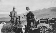 Frank G. Carpenter beside pupmobile, between c1900 and 1916. Creator: Unknown.