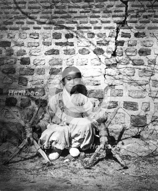 Child sitting by a wall, Korea, c1900. Artist: Unknown