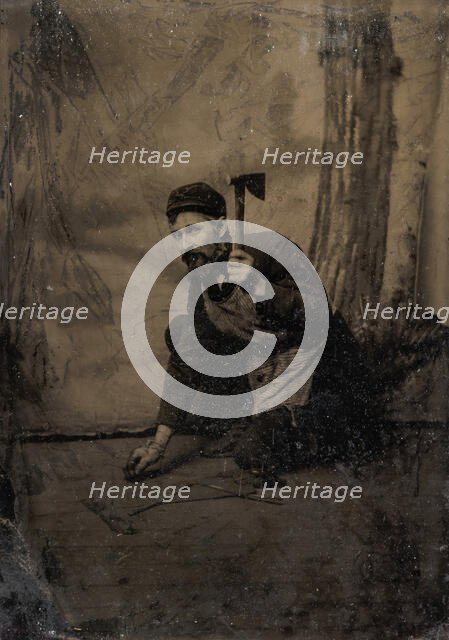 [Kneeling Carpenter Holding a Nail and Raised Hammer], 1870s-80s. Creator: Unknown.