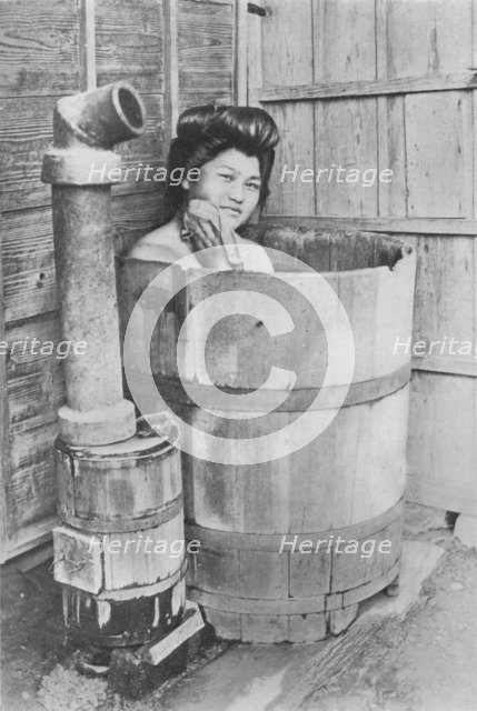 'The bath is a large barrel with charcoal stove. Frequently out of doors', c1900, (1921). Artist: Julian Leonard Street.