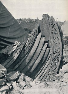 'The Oseberg ship in the mound, showing the carving on stem and railing', 1935. Artist: Unknown.