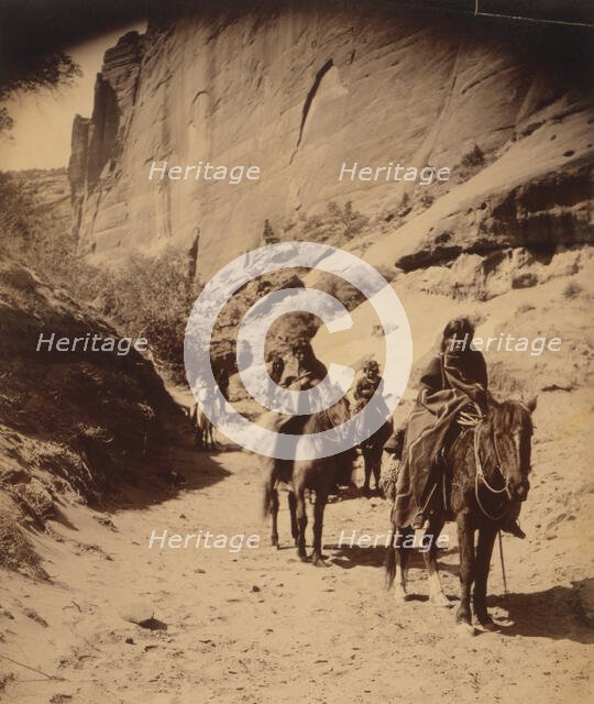 Band of mounted Navahos passing through Cañon, c1904. Creator: Edward Sheriff Curtis.